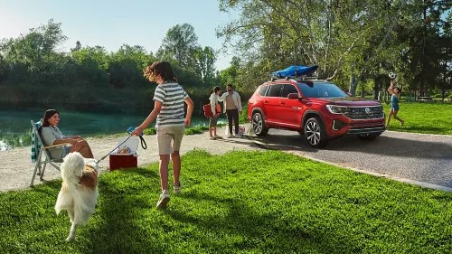 Family by a pond with their new 2025 VW Atlas