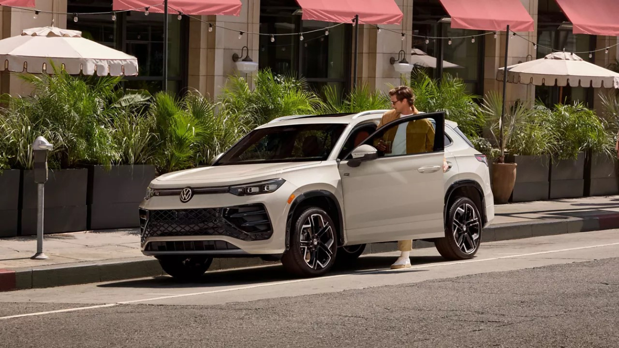 Man stepping into his 2026 Volkswagen Tiguan SEL