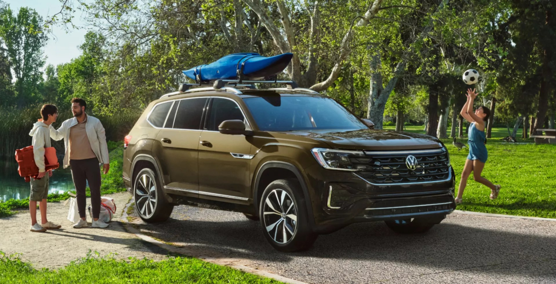 Young family gathered around their 2026 VW Atlas