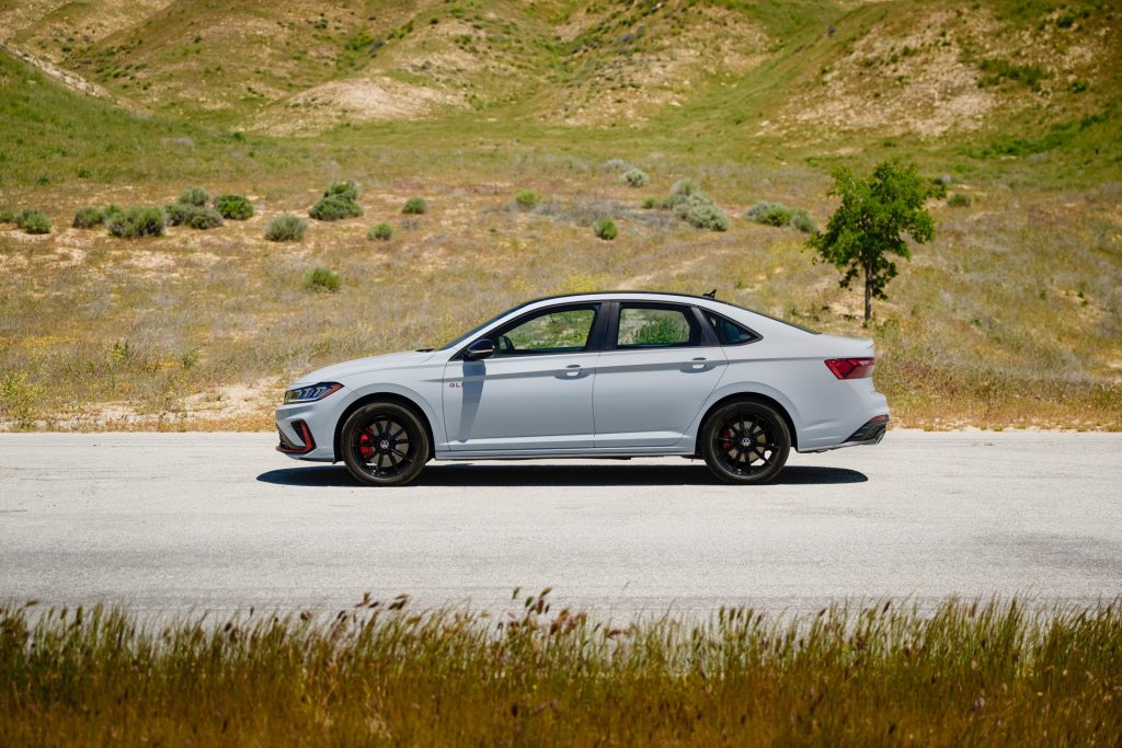 The Attractive Volkswagen Jetta GLI Driving Parked Near A Gorgeous Mountain With Beautiful Greenery