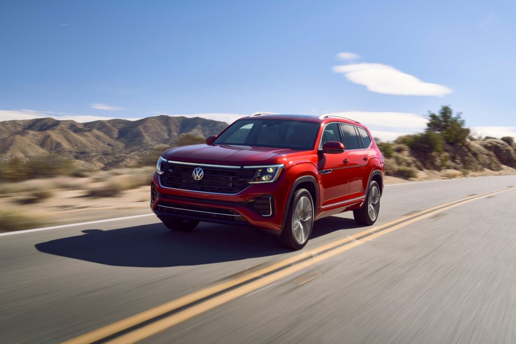 The Shimmering And Well-Reviewed Volkswagen Atlas, Driving Around A Bend In View Of Vast Mountains And A Low Valley