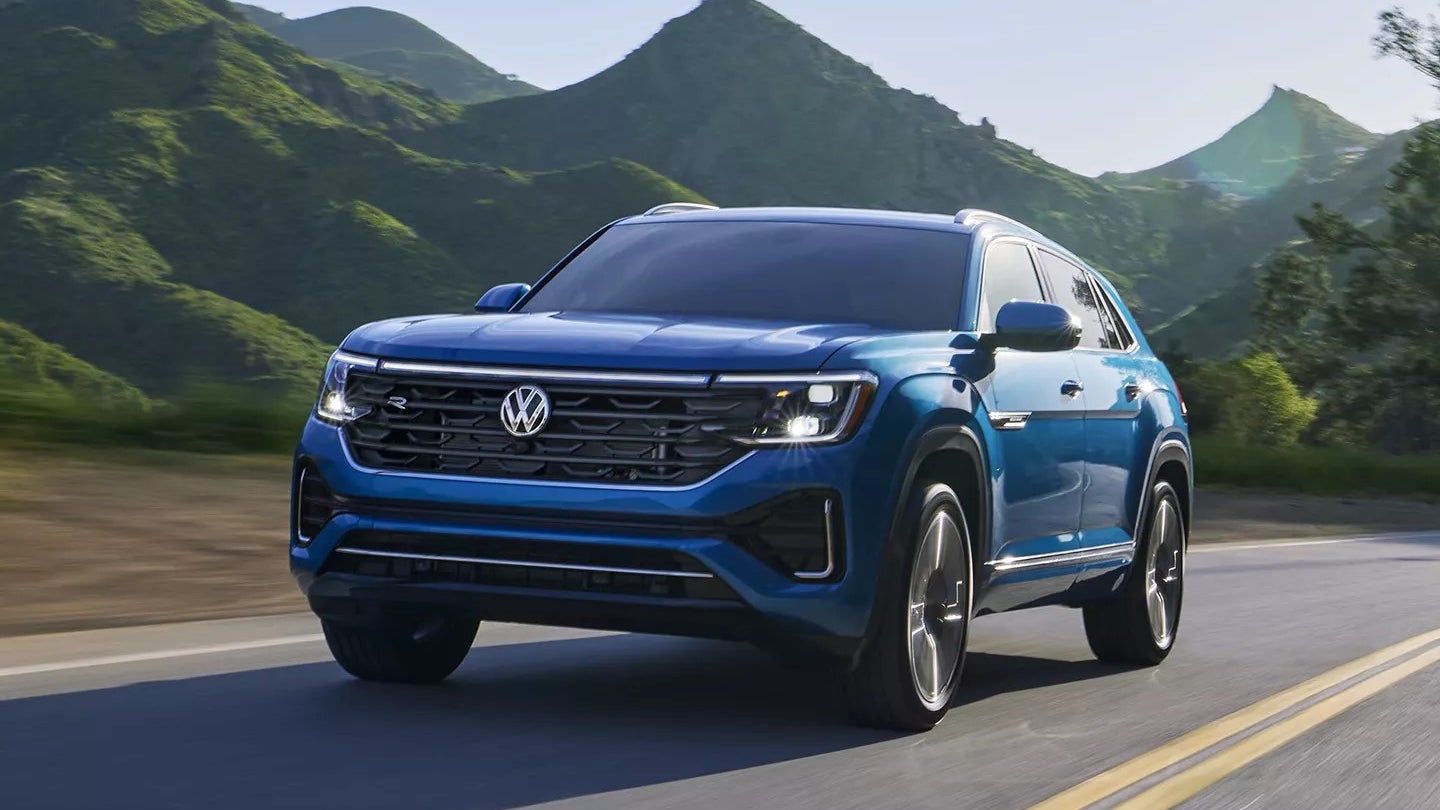 Volkswagen Atlas Cross Sport driving on a highway by mountains