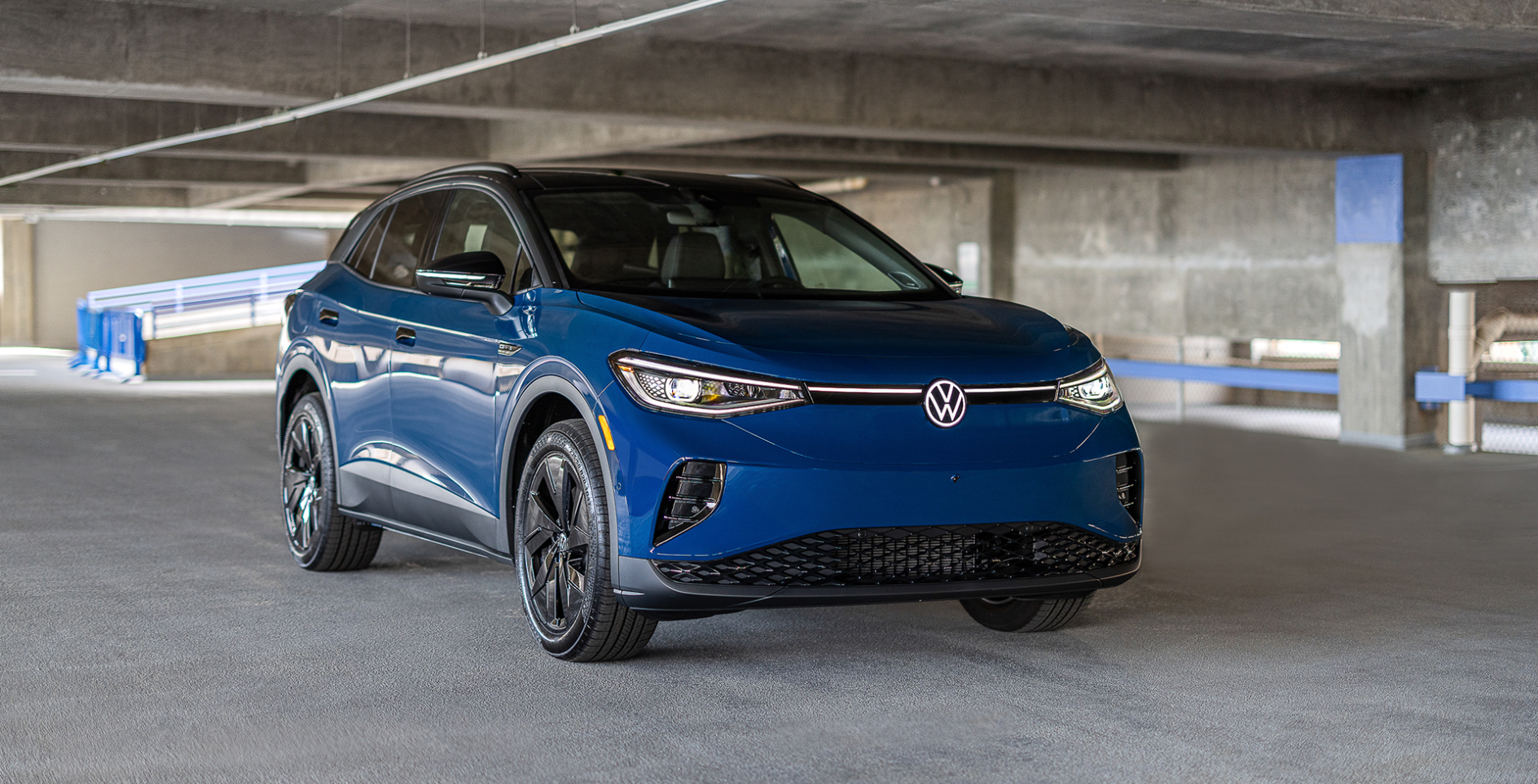 A blue Volkswagen Tiguan in a parking garage.