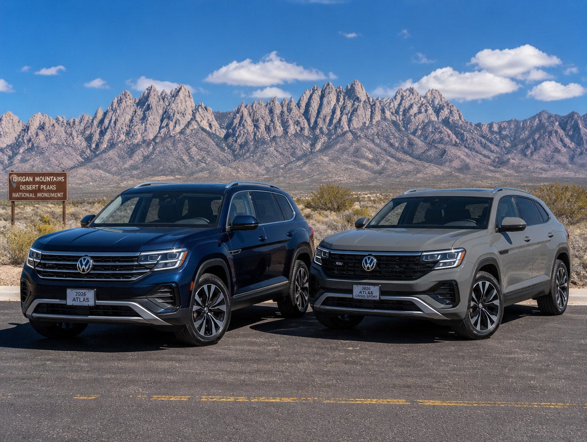 2026 Volkswagen Atlas and 2026 Volkswagen Atlas Cross Sport side by side on a southern New Mexico desert highway with the Organ Mountains behind them