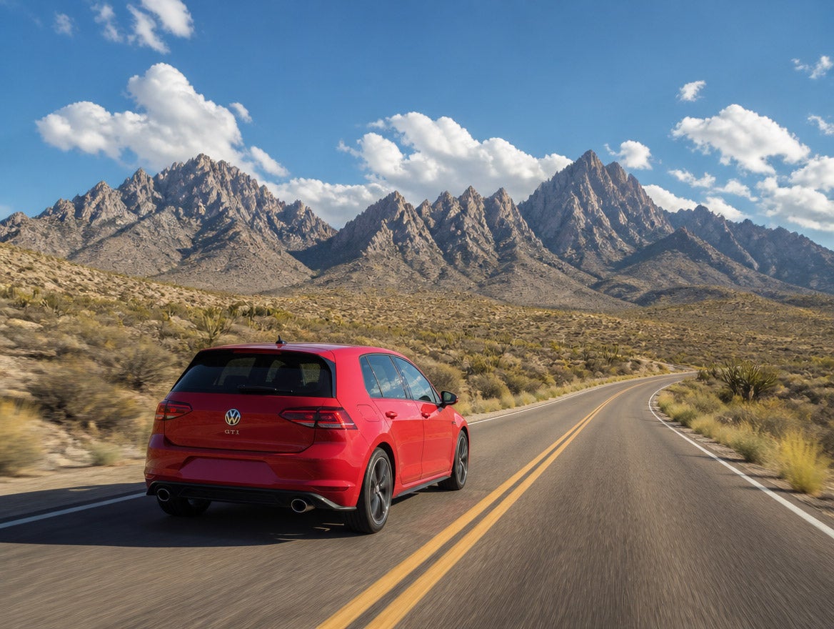 2026 Volkswagen Golf GTI on US 70 approaching San Augustin Pass with the Organ Mountains in the background, southern New Mexico